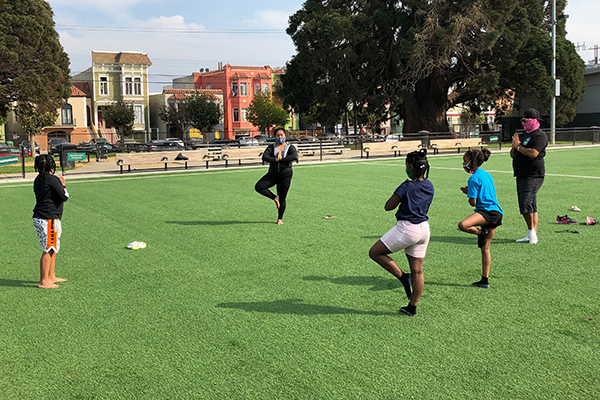 Kids and grown ups doing some physical activity in the field