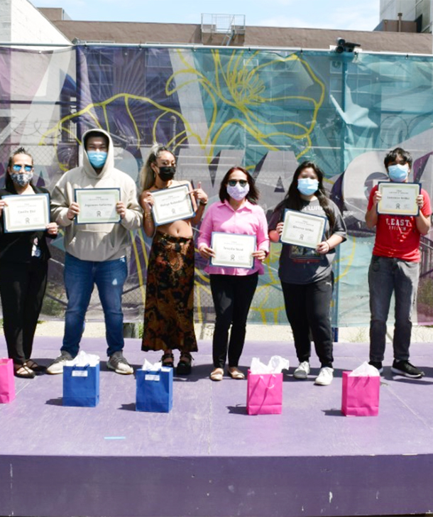 A group of students showing their diploma