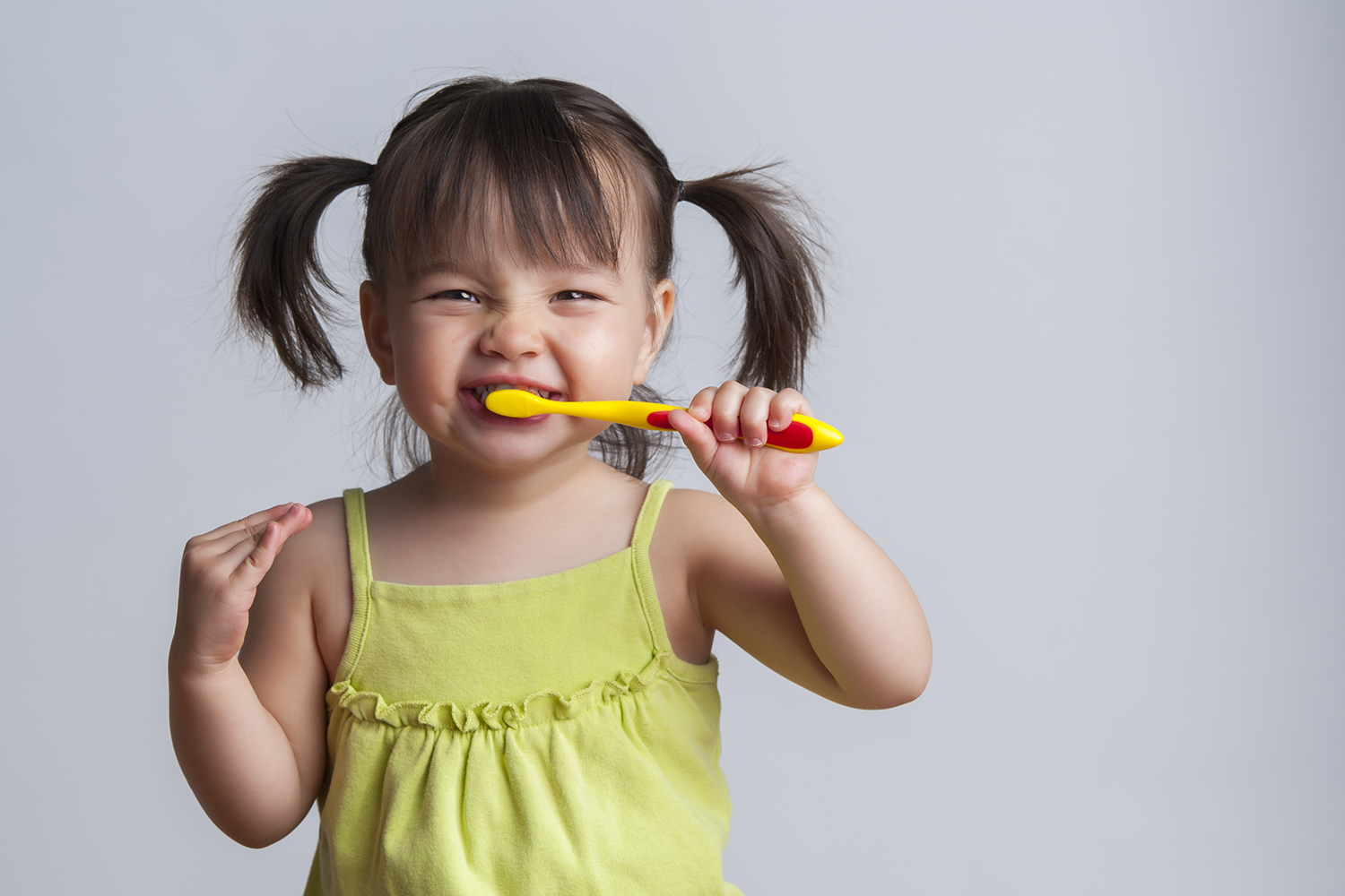 A little girl brushing her teeth